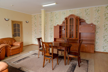 Living room interior with brown furniture and a leather chair