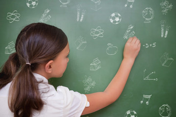 School doodles against cute pupil writing on chalkboard