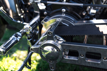 Obraz na płótnie Canvas Motorcycle close-up. Detail of a beautiful powerful chrome motorcycle engine and belt drive. The concept of freedom and travel. custom works. Metallic shiny new internal combustion engine