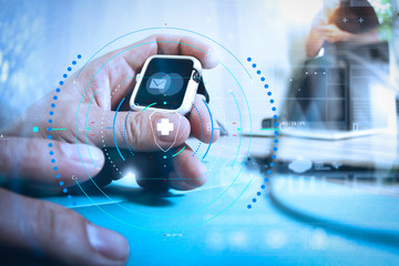 business presentation meeting on office table with smart watch and laptop computer and graph business diagram and three colleagues discussing data in the background