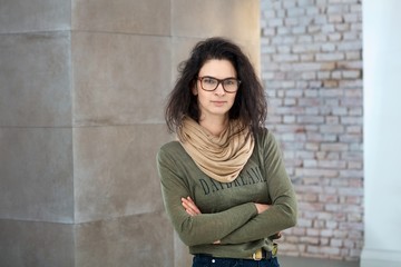 Indoor portrait of stylish adult woman in glasses