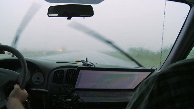 Inside a storm chaser's van on a rainy road 