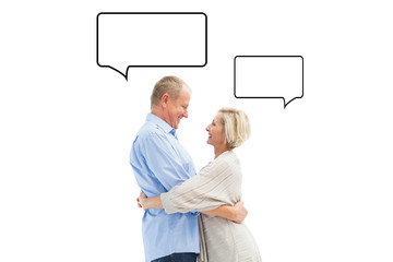 Happy mature couple hugging and smiling against speech bubble