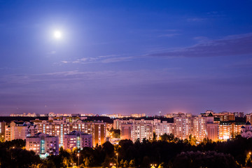 The moon shines over the city