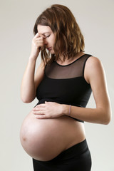 Pregnant woman with migraine symptoms - studio shot