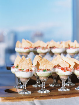 Close-up of chips and salsa served in glasses