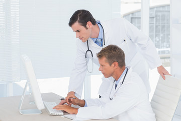 Concentrated doctors working with computer