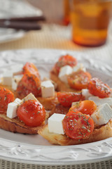 Crostinis with feta cheese and tomato