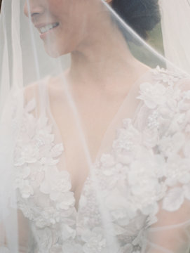 Mid section of a bride in her wedding dress