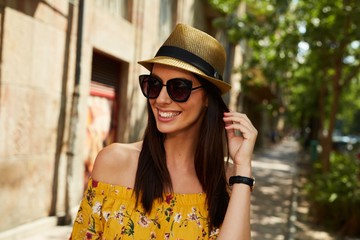 Happy young woman on the street outdoor in summer