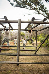 Soldiers climbing monkey bars