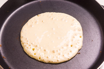 Pancake fried in a frying pan - top view
