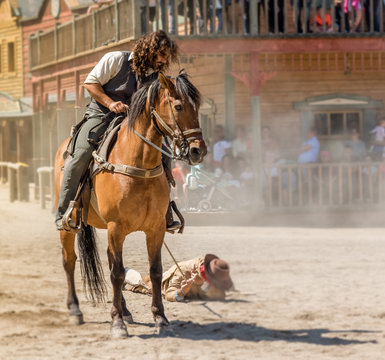 film specialist doing scene of cowboys dragging the bandit tied to the horse