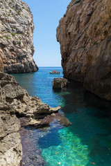 Fototapeta na wymiar Wied Babu, at Wied iz-Zurrieq, azure blue turquoise waters at the bottom of the valley, next to the Blue Grotto, Zurrieq, Malta, May 2017