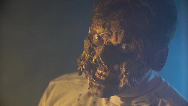 scary zombie closeup on dark background