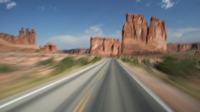 High-speed driver's POV of highway through Arches National Park, Utah
