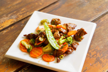 Beef tenderloin with vegetables, chinese food on a white plate. - 202999251