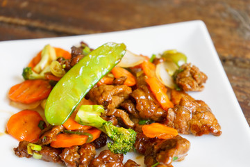 Beef tenderloin with vegetables, chinese food on a white plate. - 202999293