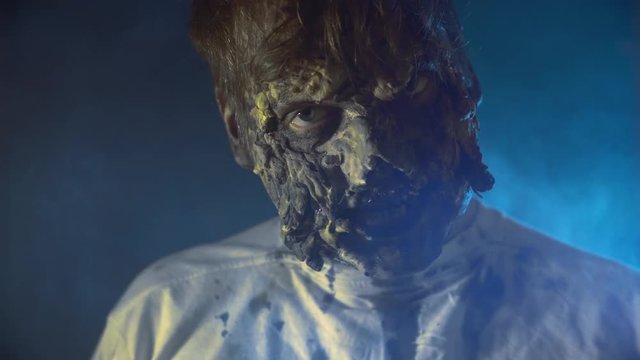 scary zombie closeup on dark background