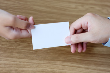 Hand giving blank white business card with copy space for text, business mock up background concept