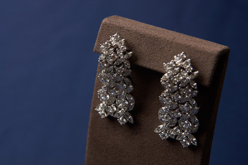 Close up of diamond earrings. Beautiful luxury brilliant jewelry