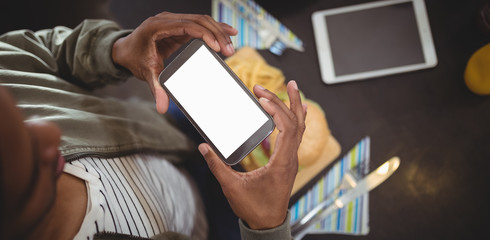 High angle view of man photographing fast-food at cafe