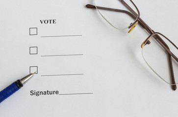 Form for voting and signing near the pen, glasses