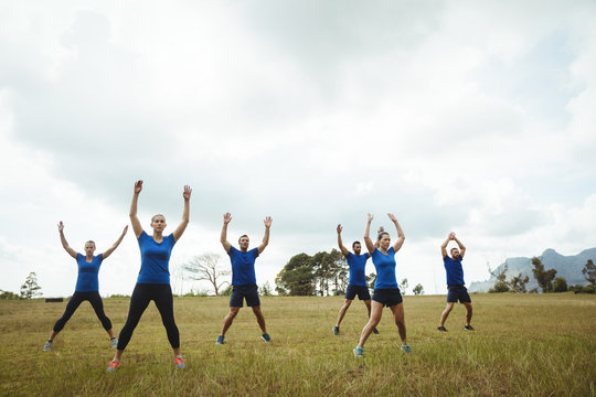 Fit people performing stretching exercise
