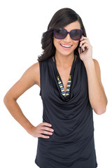 Obraz premium Cheerful elegant brunette on the phone wearing sunglasses