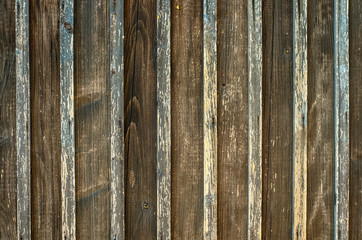 Old wooden fence background texture.
Aged rough rustic vertical brown color planks as a wall or floor background texture.