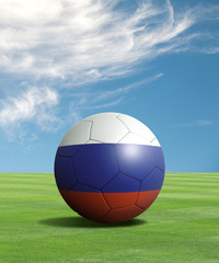Soccer ball with Russia flags in a green field
