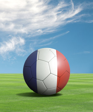 Soccer ball with France flags in a green field
