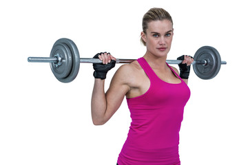 Sporty female bodybuilder lifting barebell 