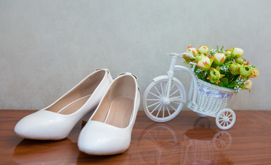 Glamorous white wedding shoes with a decor