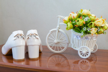 Glamorous white wedding shoes with a decor