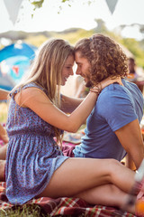 Hipster couple smiling at each other