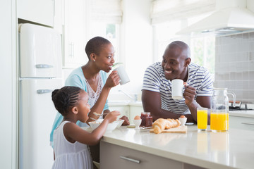 Happy family sitting and taking breakfast