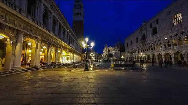 Piazza San Marco and Basilica of St Mark night timelapse. Cathedral church of Roman Catholic Archdiocese of Venice. Tourists walking in front of it. 4K
