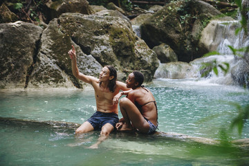 Fototapeta na wymiar Couple enjoying the waterfall