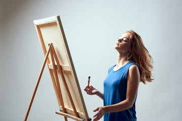 woman painting on easel