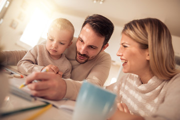 Smiling family drawing together