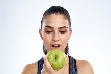 portrait of young woman with green apple