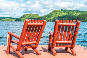 Wooden chairs on the dock on a late summers afternoon