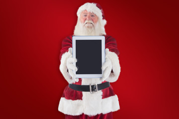 Santa presents a tablet PC against red background