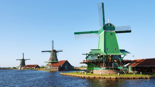 Three Zaanse Schans windmills on the water channel in Zaanstad near Zaandam / Zaandam, North Holland, Netherlands. Shot with RED Weapon Helium 8K camera. 