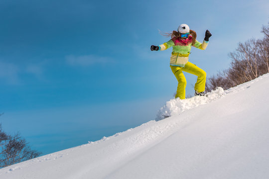 Happy young woman snowboard in deep snow