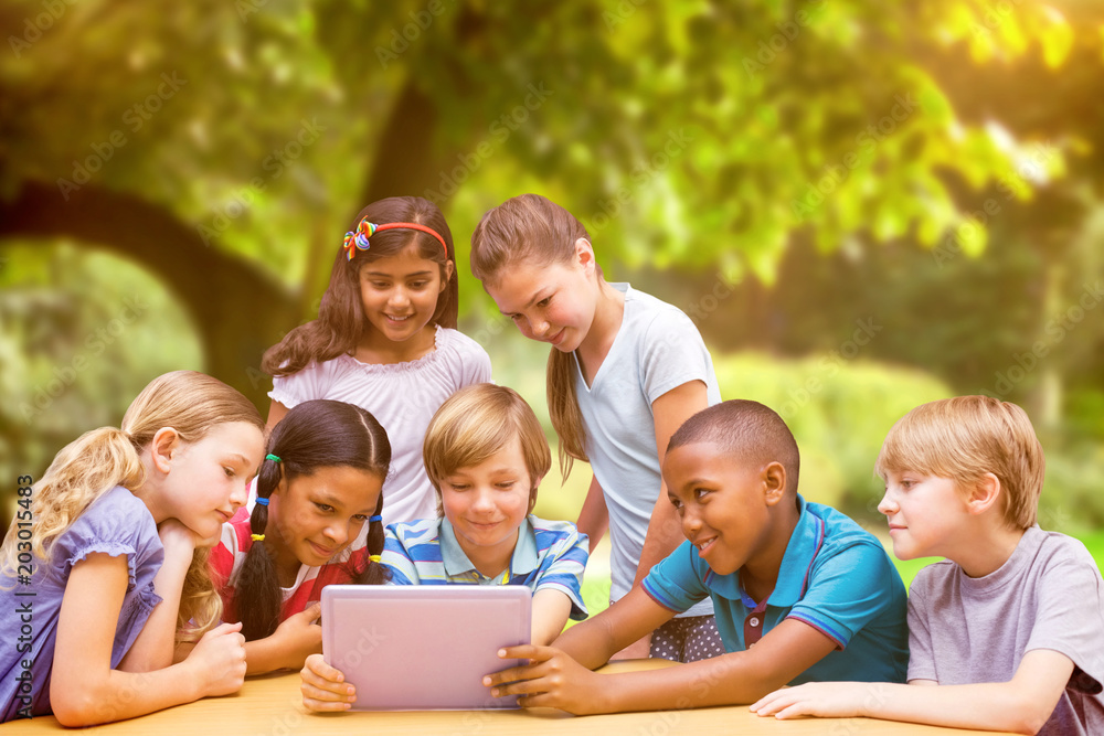 Poster cute pupils using tablet computer in library against trees and meadow in the park