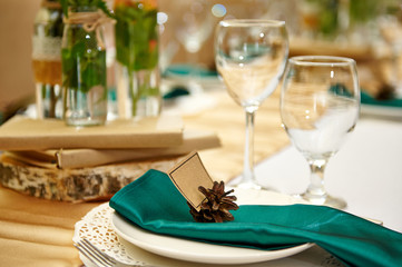 Festive table setting in the restaurant with flowers. Wedding decor.