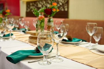 Festive table setting in the restaurant with flowers. Wedding decor.