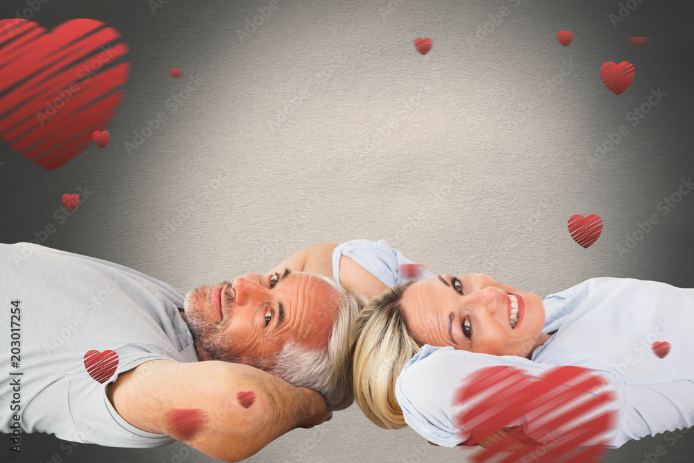 Aufkleber smiling couple lying and looking at camera against white background with vignette